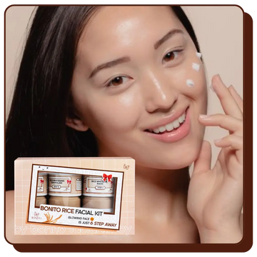 Woman applying cream to her face with a Bonito Rice Facial Kit box in the corner.