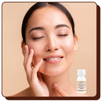 Woman touching her face with a bottle of skincare product on a beige background